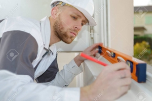 worker measuring the window size